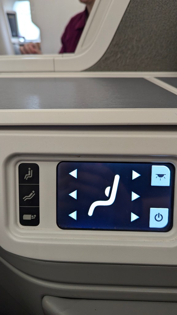 Close-up of the seat control panel in Thai Airways business class, featuring icons for seat adjustments, lighting, and other functions.
