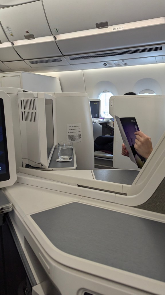 Interior view of Thai Airways Boeing 787-9 business class cabin, showcasing the seating arrangement and in-flight entertainment system.